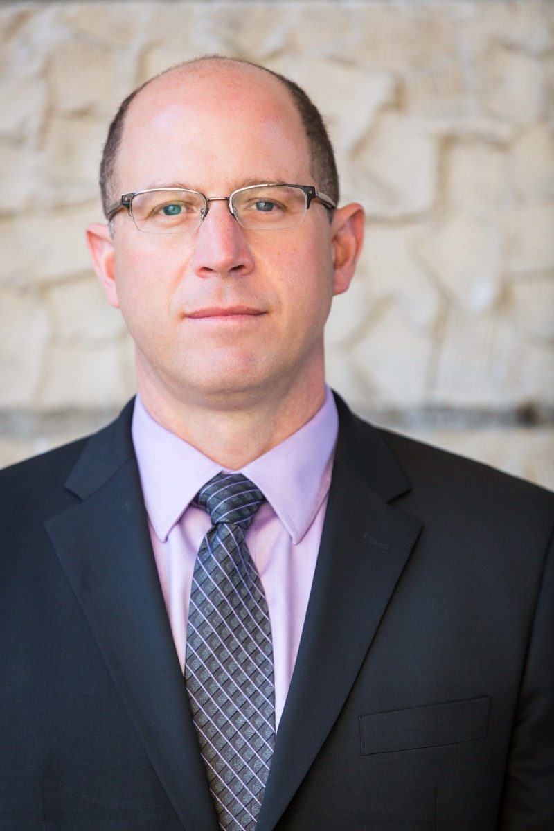 Corporate headshot of a man in a suit and tie